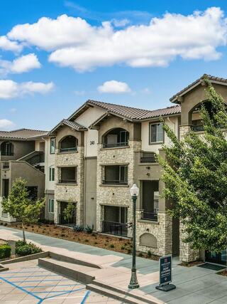 Exterior view of Towne Centre Apartments featuring modern residential architecture, landscaped walkways, and upscale multifamily living in a suburban community setting.