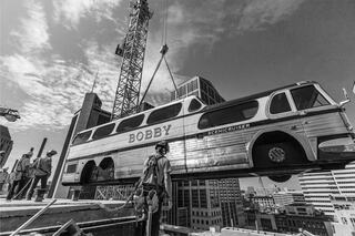 Vintage bus installation on Rooftop Lounge at Bobby Hotel Nashville – iconic Scenicruiser being lifted by crane atop downtown Nashville hotel.